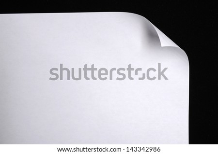 Sheet of paper folded over black background