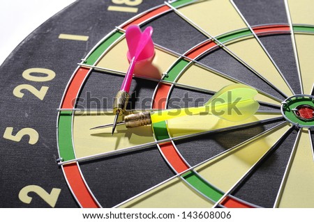 Dart arrows lying in the dart board