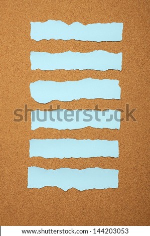 Set of blue torn piece of paper over brown background