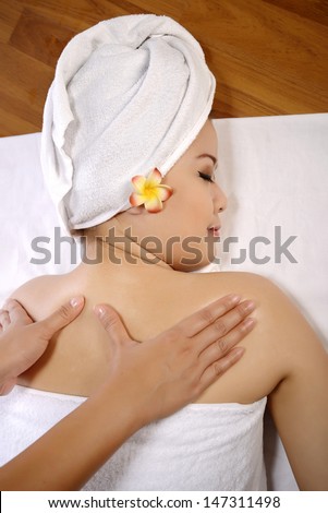 Beautiful asian woman get back rub massage on the spa