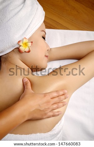 Beautiful asian woman get back rub massage on the spa