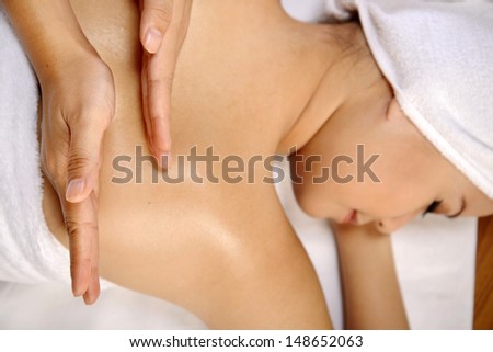 Beautiful asian woman get back rub massage on the spa.