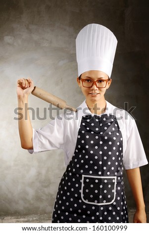 Mad woman chef get angry holding utensils