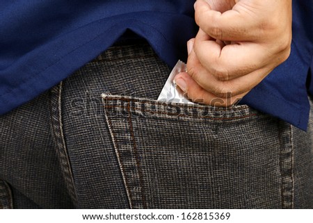 Man hand picked condom in his pocket pants