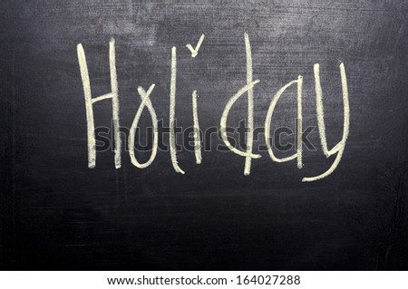 Holiday Concept. Holiday write with chalk on the blackboard