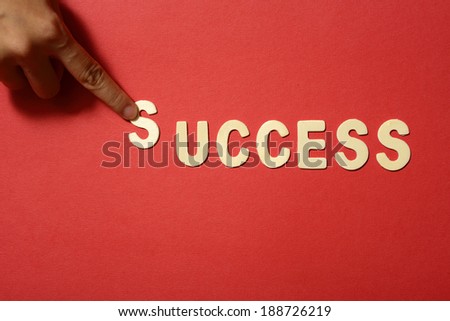 Success text on red paper background
