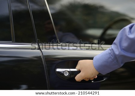 Automotive and transportation concept. Man hand on door handle of car