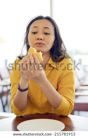 Pretty Young Woman Eating Burger Enjoying Break Lunch In Cafe
