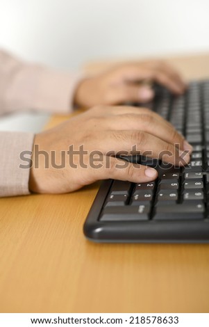 Business man typing with keyboard in his desk