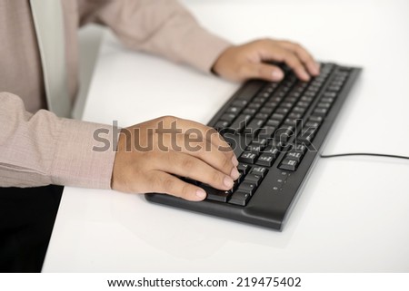 Business man typing with the keyboard on white desk