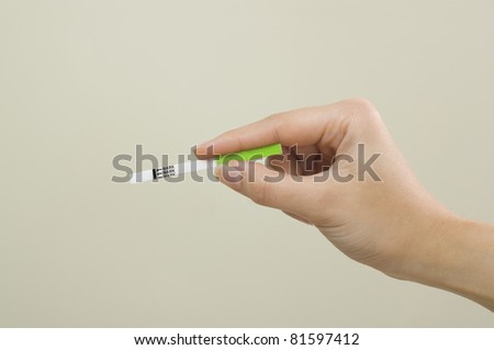 Woman hand hold pregnancy test with negative result