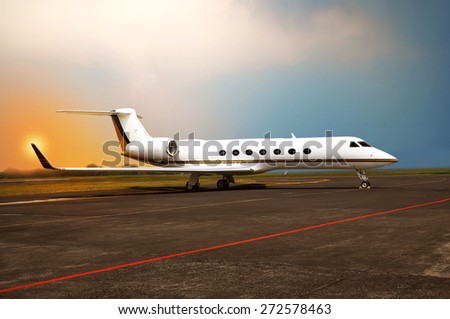 Private jet airplane parking at the airport. With sunset background