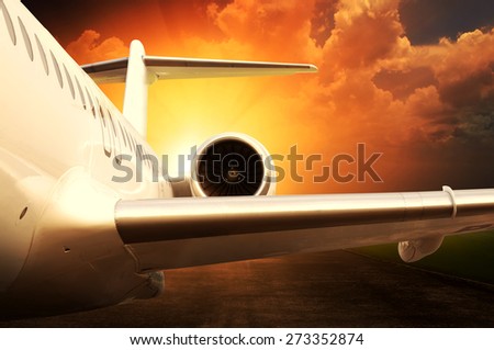 Jet engine on parked airplane over sunset background