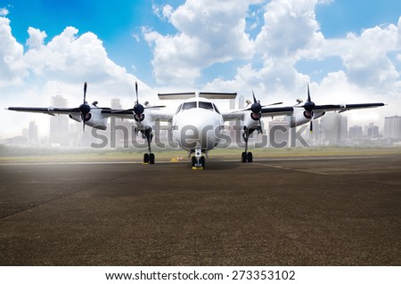 Propeller airplane parking at the airport. With blue sky and cloud background
