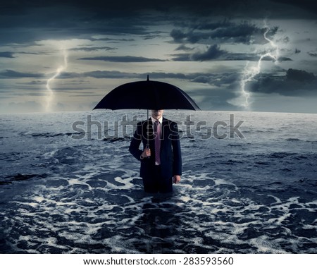 Business man standing on the sea in the middle of storm