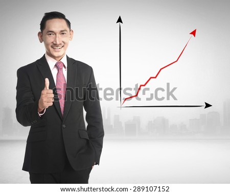 Asian business man show thumb up because sales increasing