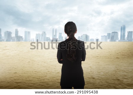 Asian business woman looking the city on the desert. Business vision concept