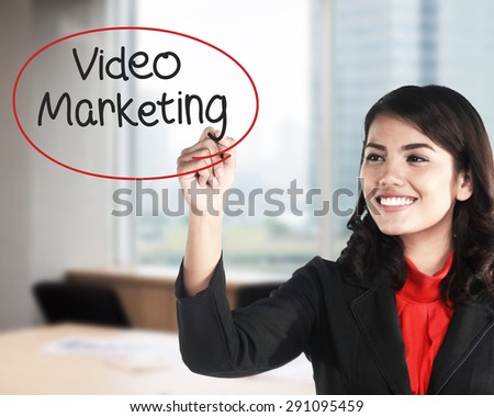 Business woman writing video marketing with handwriting and circle