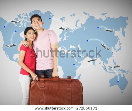 Young couple planning to travel around the world. Travel conceptual image