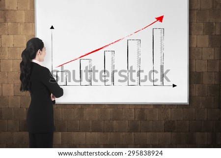 Back view young woman with white board. There increasing chart image