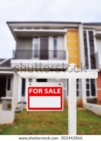 House for sale board with house background. You can put your number on the board