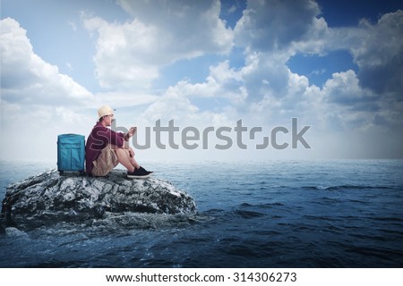 Asian traveler man alone at the small island on the sea