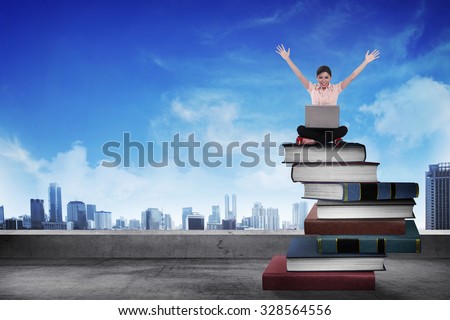 Business person working with laptop on  the top of books. Career and education concept