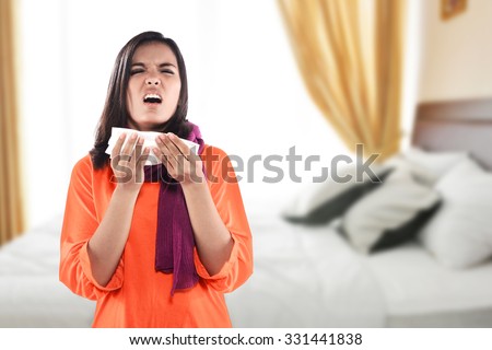 Young sick woman having cold with bedroom background