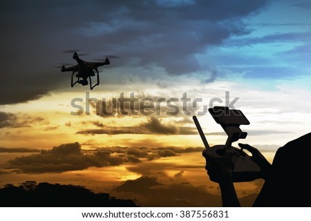 Male pilot controlling drone with remote control