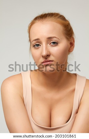 Beautiful young pretty blonde girl with big breasts to express emotions sorrow, grief, woe, distress, misery, trouble