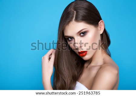 Portrait of young beautiful perfect sexy woman with long smooth hair well-groomed, fashionable styling hair, evening make-up organic cosmetics, facial features in a beauty salon
