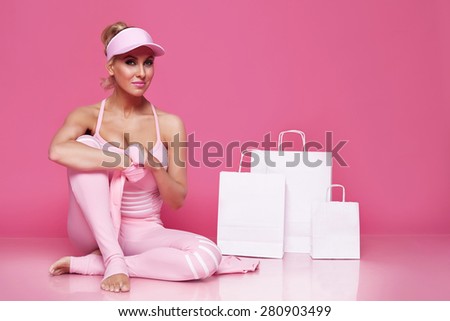 Beautiful sexy blonde woman perfect athletic slim figure engaged in yoga, exercise or fitness, lead healthy lifestyle, wear in comfortable casual clothes pink doll style sport pilates diet body shape