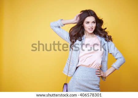 Business woman in office clothes wear costume flax jacket and skirt light blue silk pink hold hand lather bag goods accessory fashion style collection glamour pose model natural beauty makeup perfect