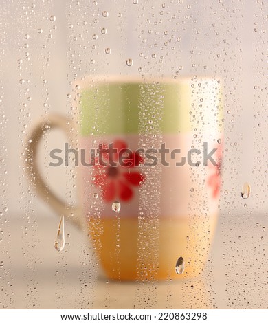 focus of water drops with coffee cup for background (warm tone picture)