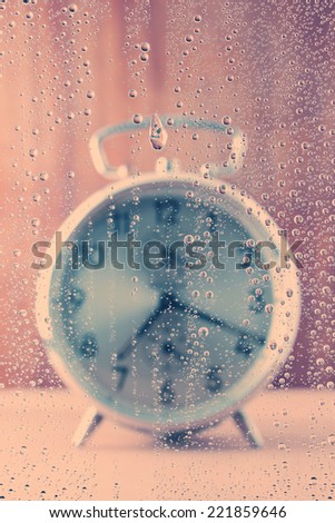 focus of water drops (alarm clock for background)