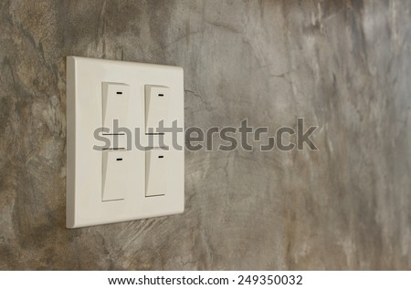 light switch on cement wall background