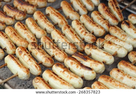 grilled banana skewers on stove in market