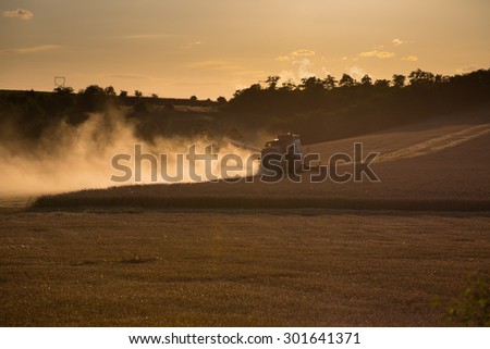 Combine harvested grain at sunset. Simple monochrome image. Widespread Dust