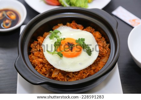 Fried rice with egg, Vietnamese style. It is a combination between cooked rice, green pea, dried shrimp and cashew oil. You can decorate it with added omelet, coriander leaves, grindded pepper
