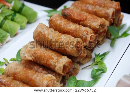 Spring rolls (Cha gio), Vietnamese cuisine. A combination of pork meat or shrimp and vegetable wrapped in rice paper and deep fried. Served with fish sauce or ketchup.