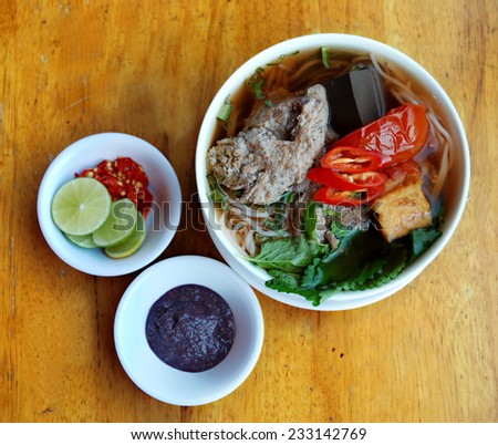 Vietnamese crab noodle soup (Bun rieu), Vietnamese Cuisine. A meal cooked with pork stock, broth (made by crab mixture and pork/chicken stock, dried shrimp), tomatoes, light fried tofu, shrimp paste.
