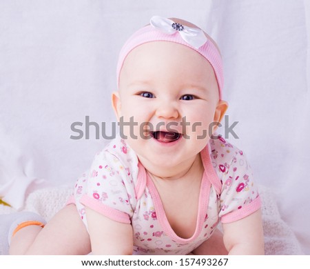 Baby with blue eyes smiling, 7 month newborn baby