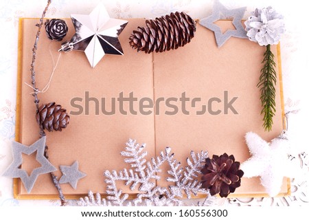 Open old book with brown paper, cones and felt stars for Christmas design