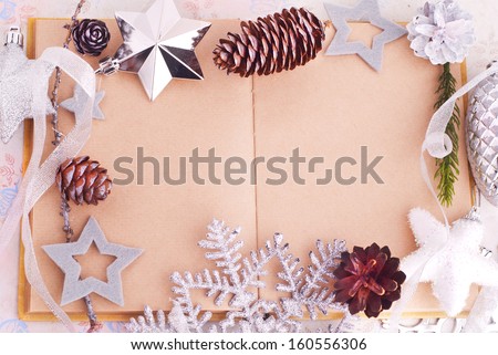 Open old book with brown paper, cones and felt stars for Christmas design