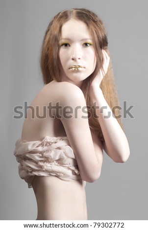 Portrait of beautiful woman with gold lips