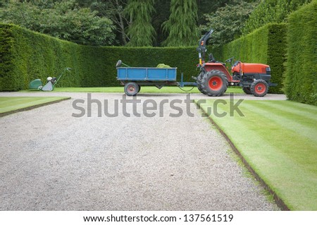 Garden tractor with trailer in English garden