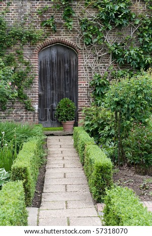 Secret garden. English garden path and door