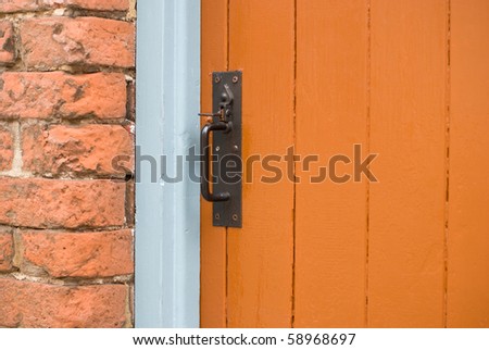Orange wooden door, victorian house. Suffolk, UK.