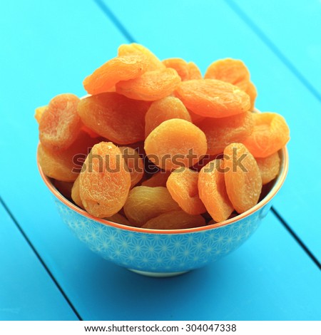 Dried apricots on a blue table