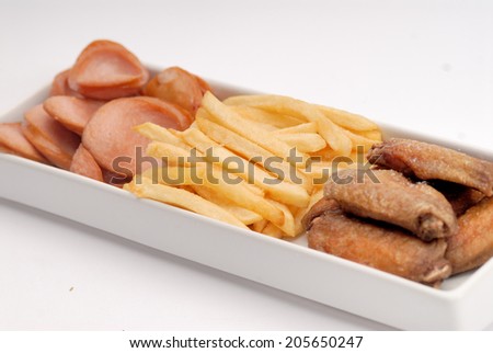 French fries, chicken wings, fried sausage.